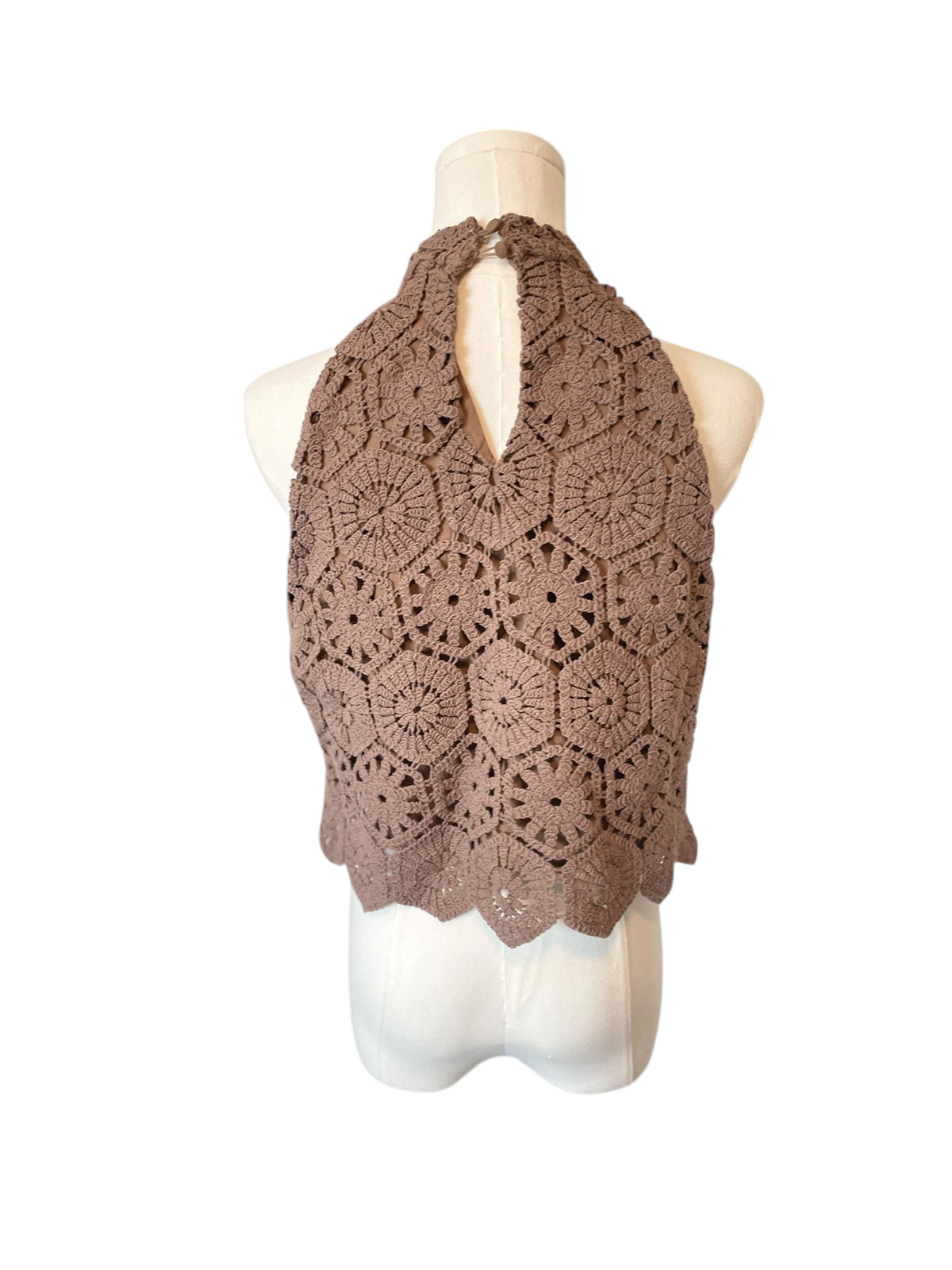 Brown crochet vest on a mannequin against a white background