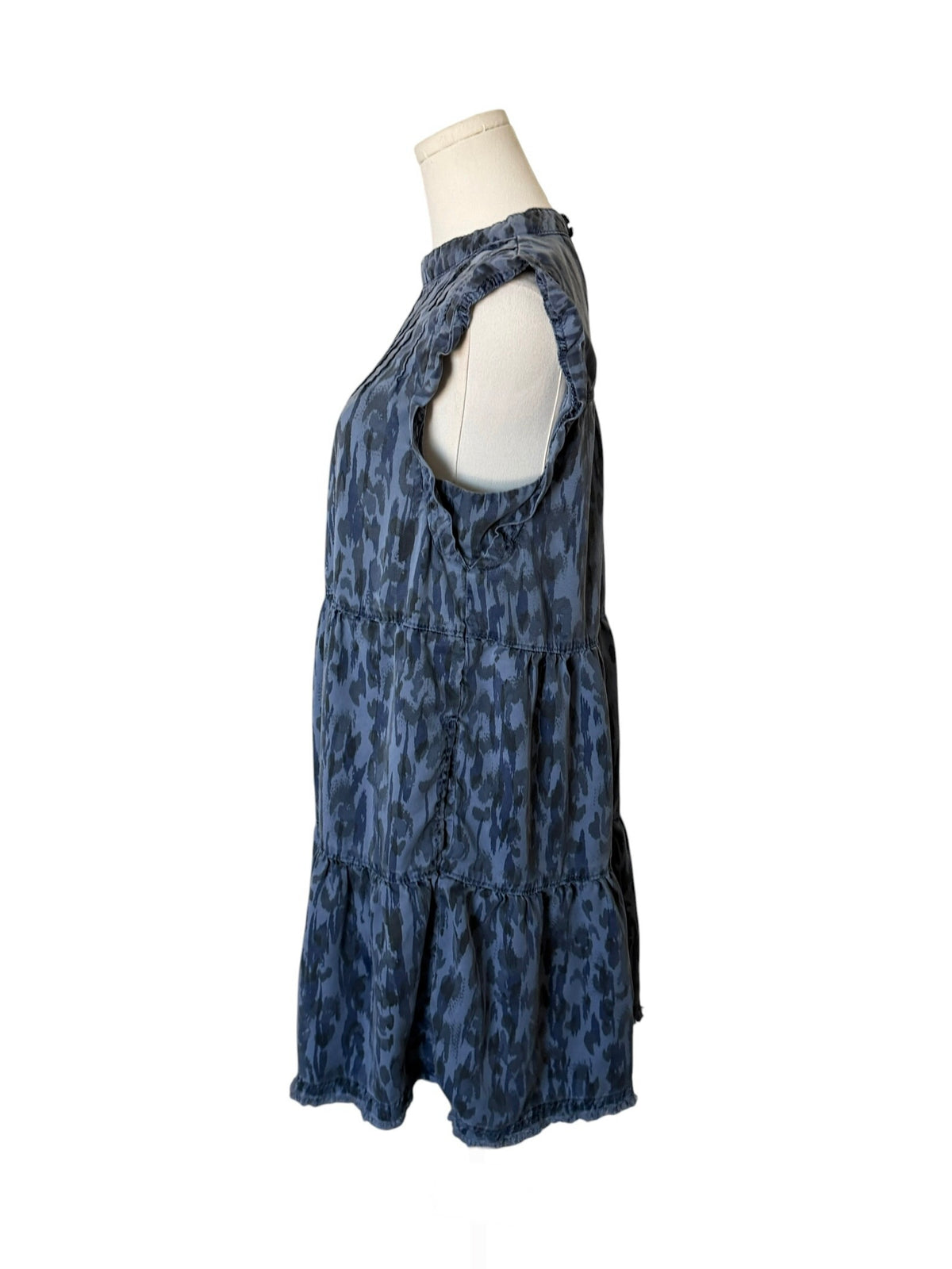 Blue patterned dress on a mannequin against a white background