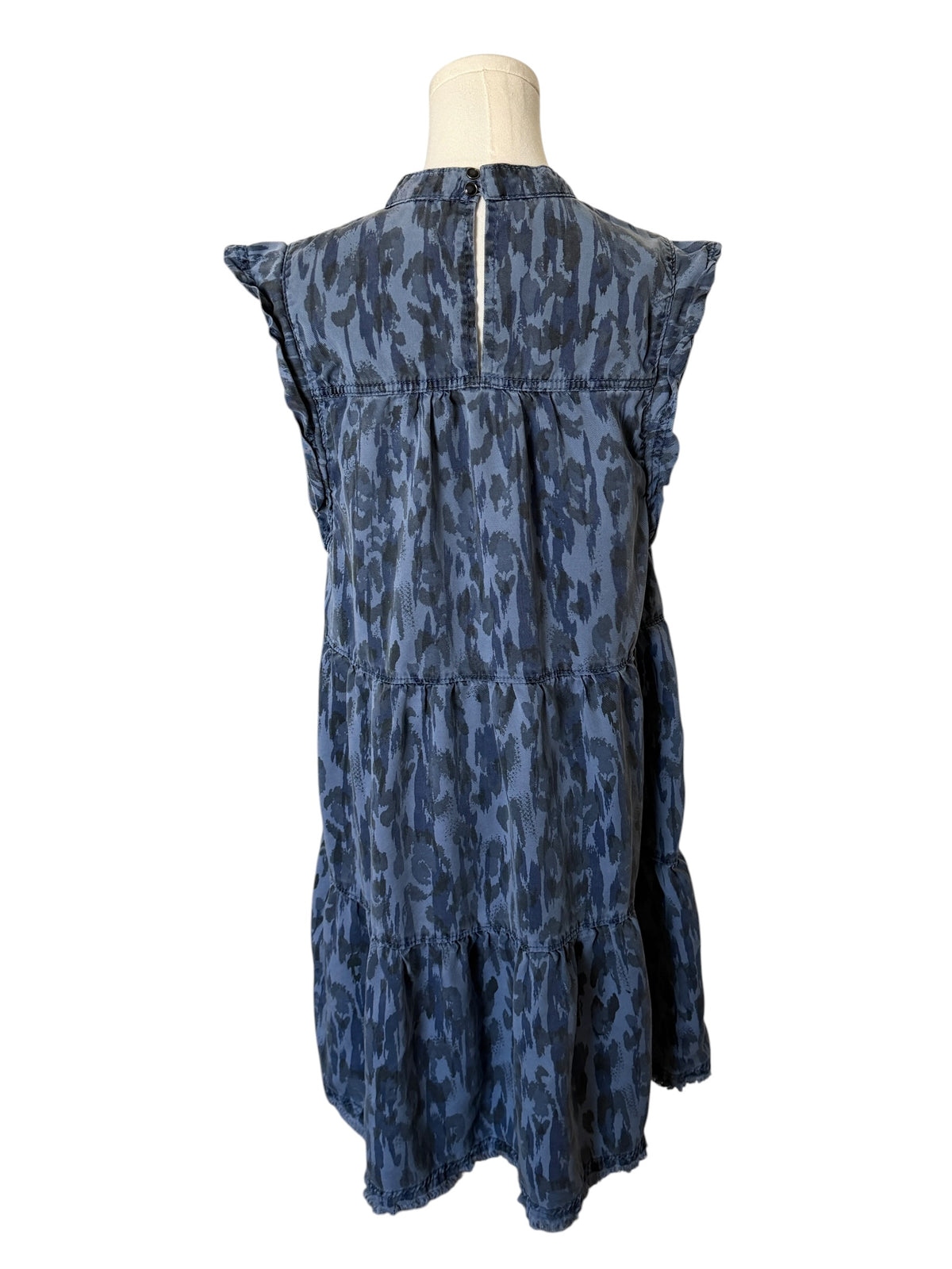 Blue patterned dress on a mannequin against a white background