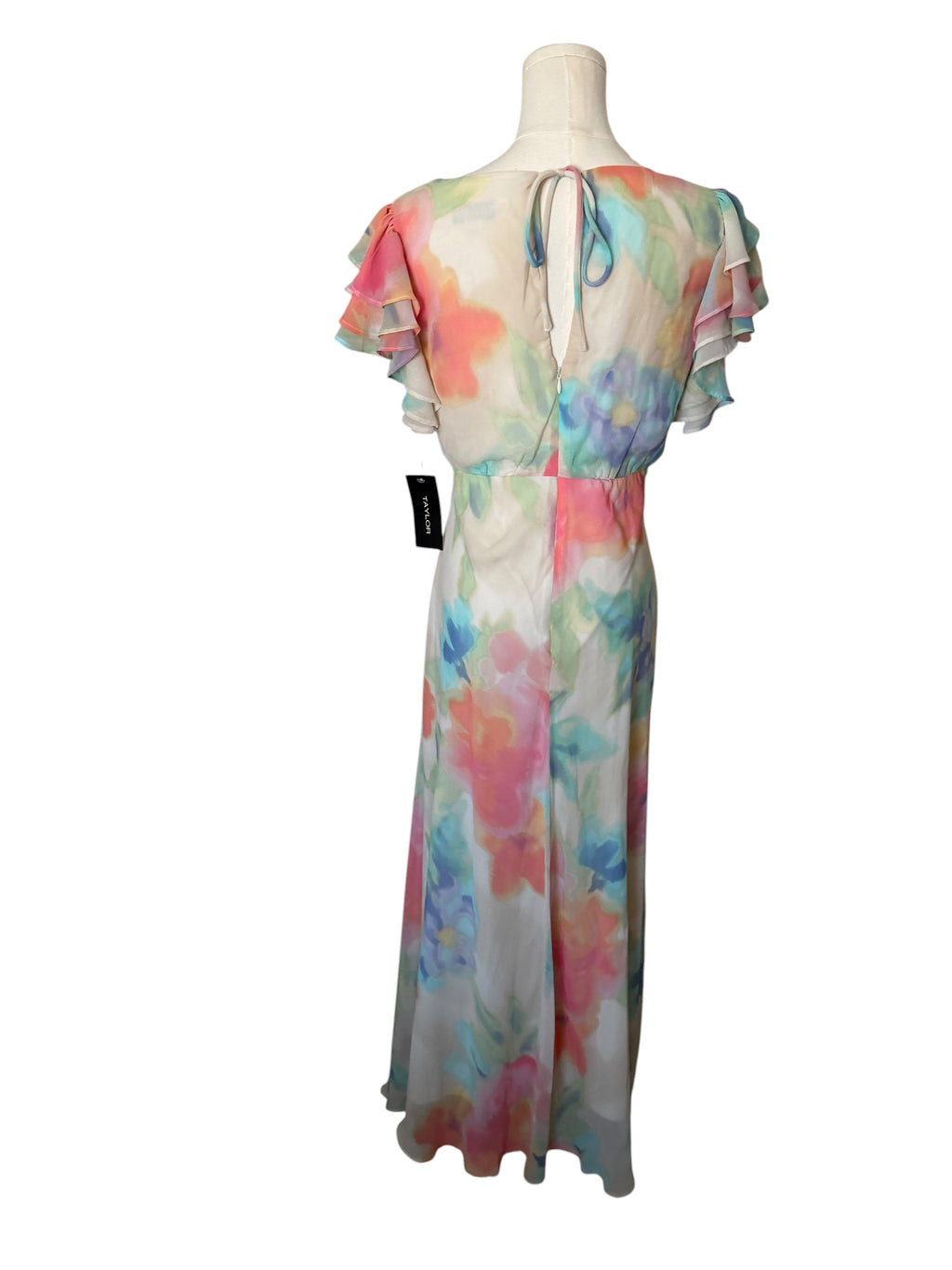Colorful floral dress on a mannequin against a white background