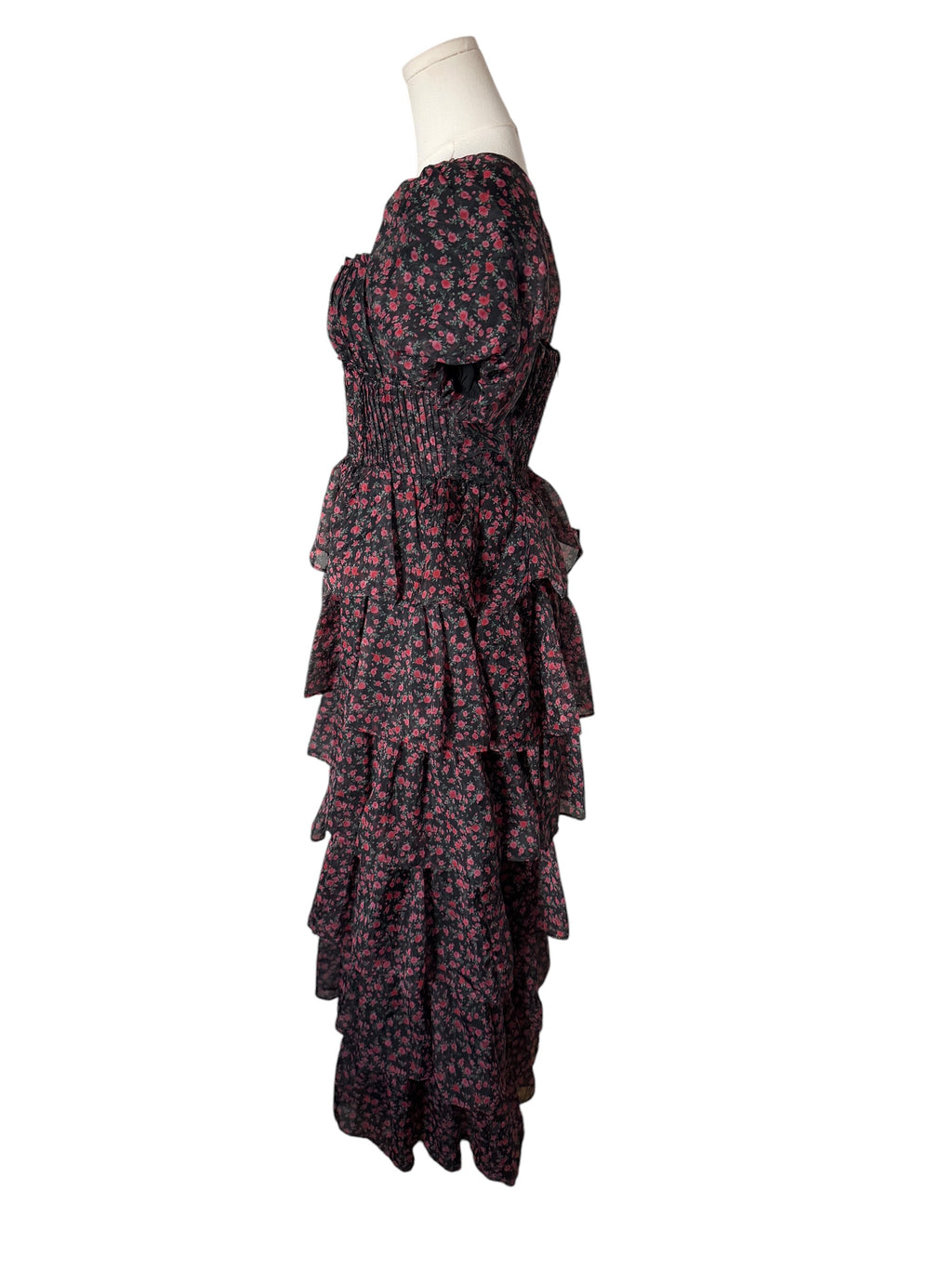A strapless tiered maxi dress with a dark floral print, displayed on a mannequin torso against a plain white background.