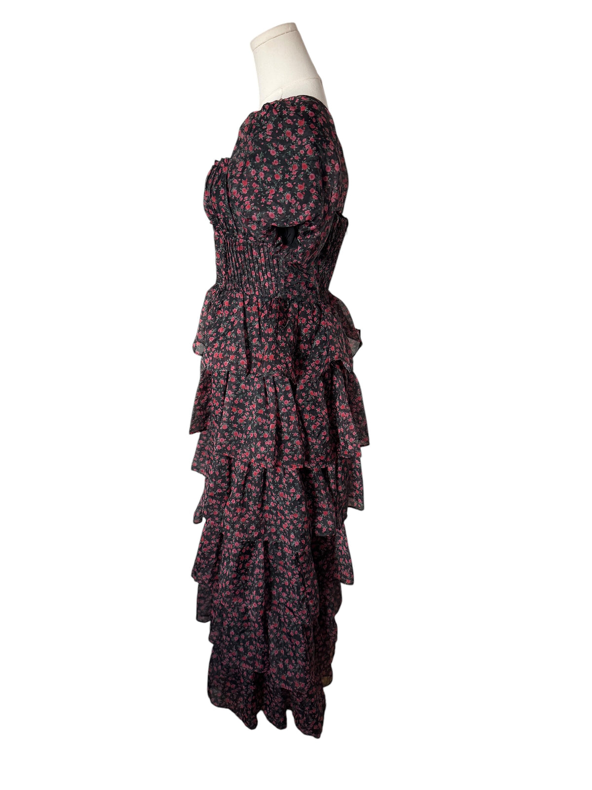 A strapless tiered maxi dress with a dark floral print, displayed on a mannequin torso against a plain white background.