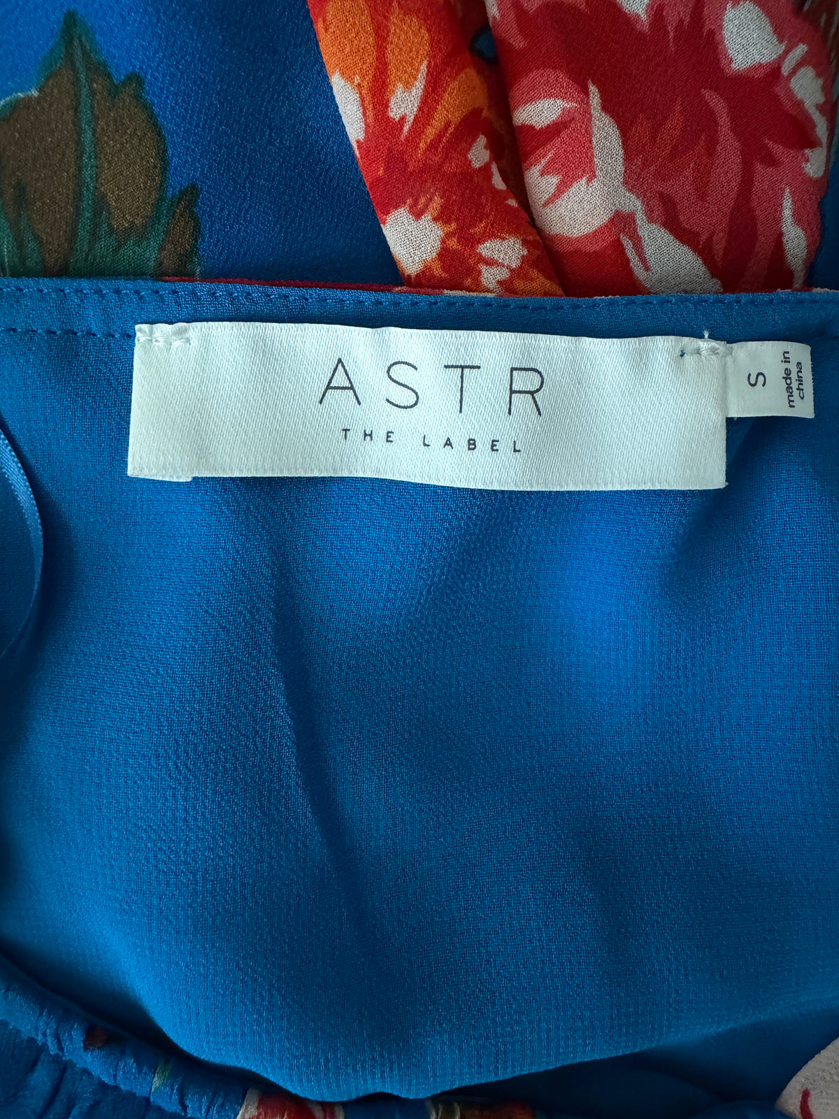 Blue fabric with 'Astr The Label' tag on a colorful background