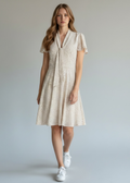 Maggy London cream-colored polka dot dress features a tie-neck detail