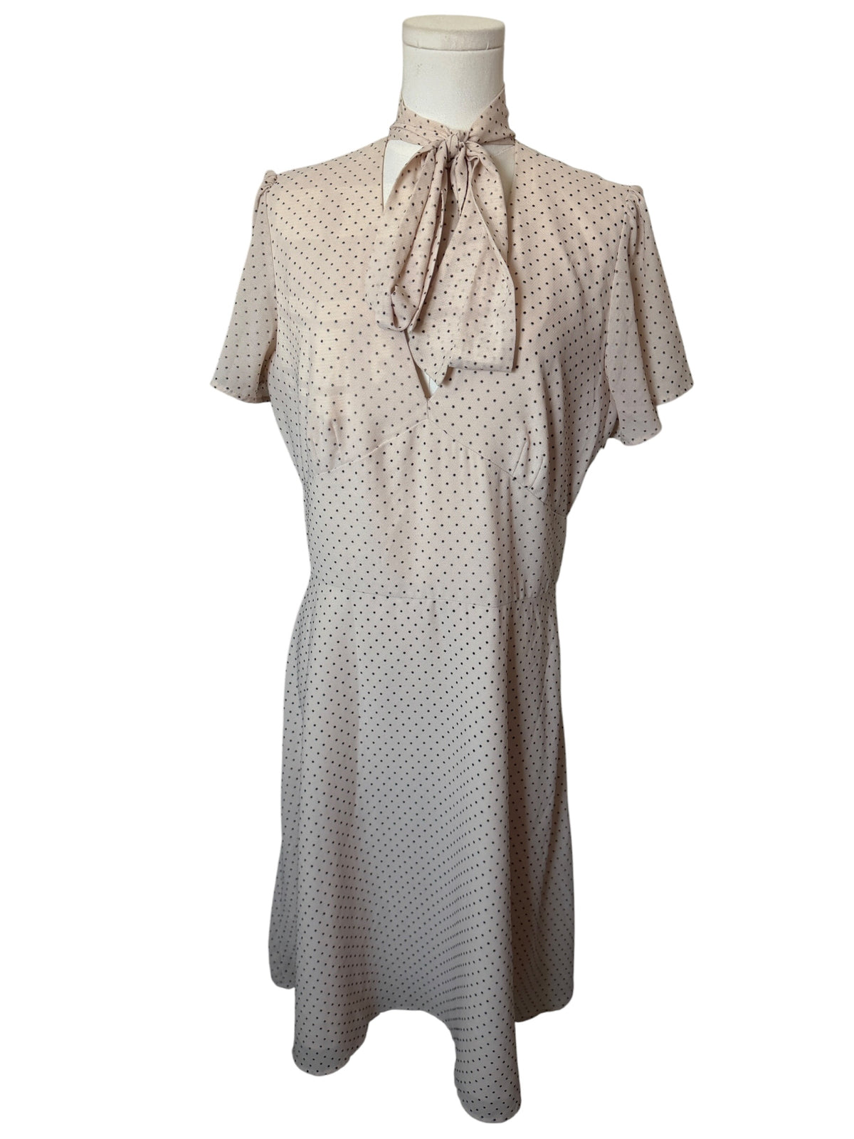 Maggy London cream-colored polka dot dress features a tie-neck detail