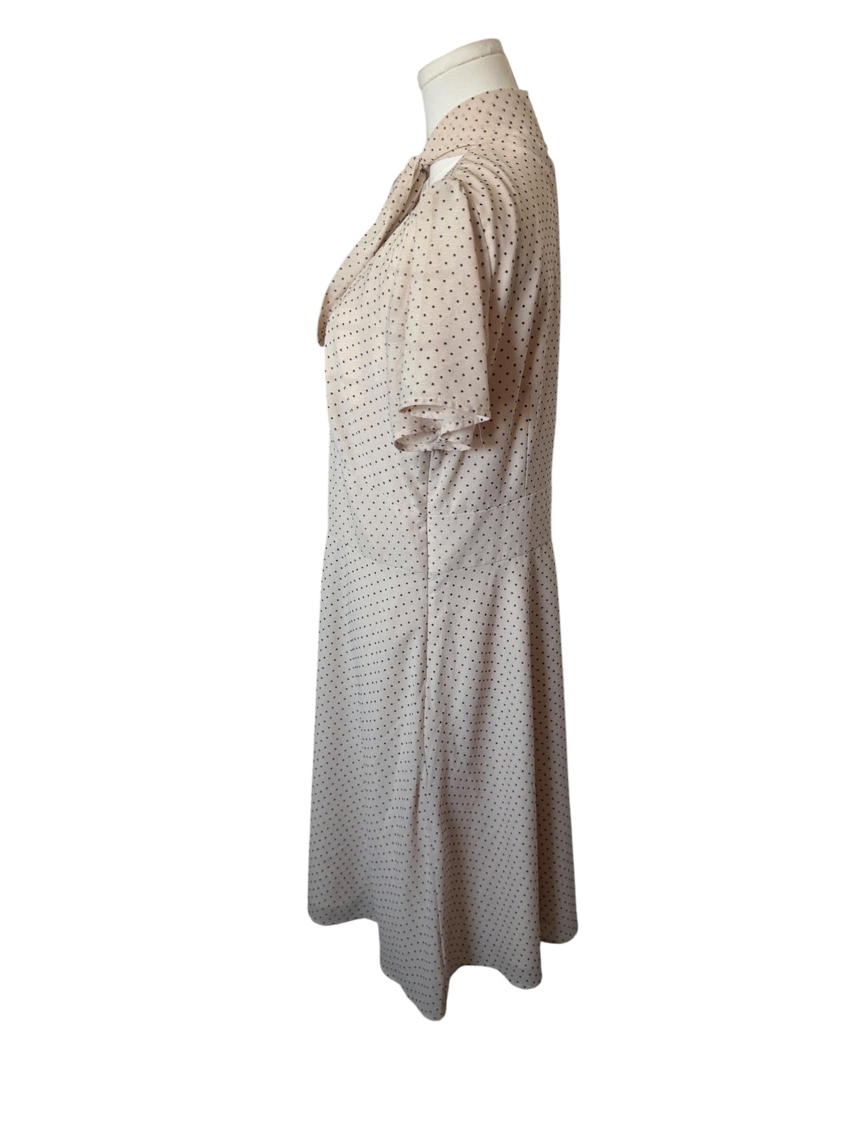 Maggy London cream-colored polka dot dress features a tie-neck detail