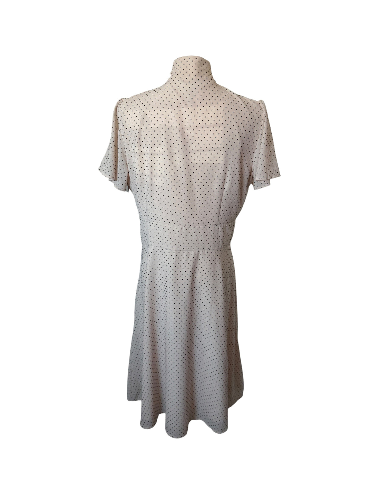 Maggy London cream-colored polka dot dress features a tie-neck detail