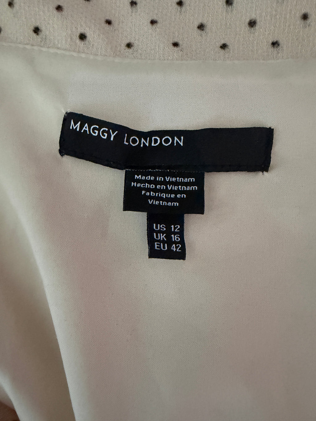 Maggy London cream-colored polka dot dress features a tie-neck detail