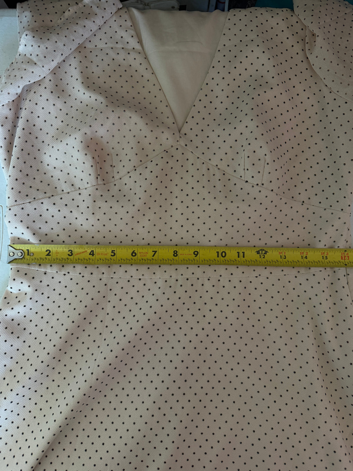 Maggy London cream-colored polka dot dress features a tie-neck detail