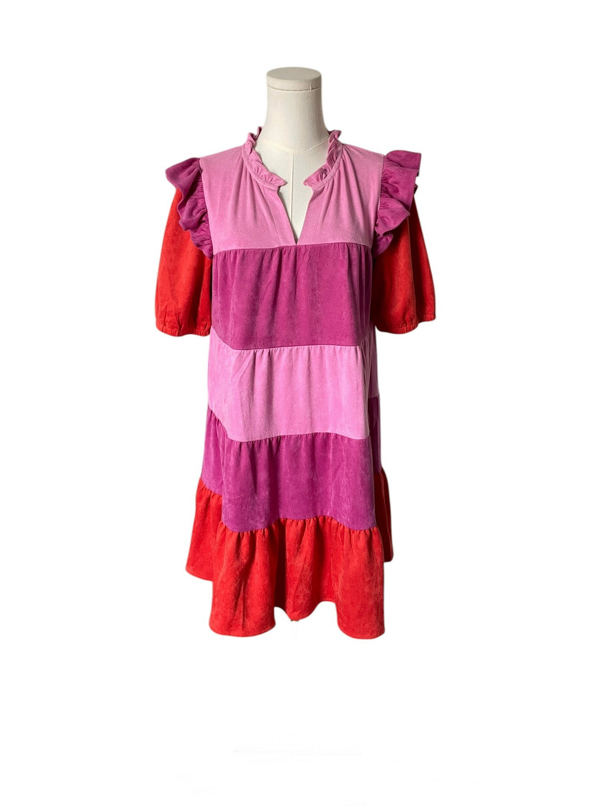 Mannequin wearing a dress with pink and red striped pattern on a white background