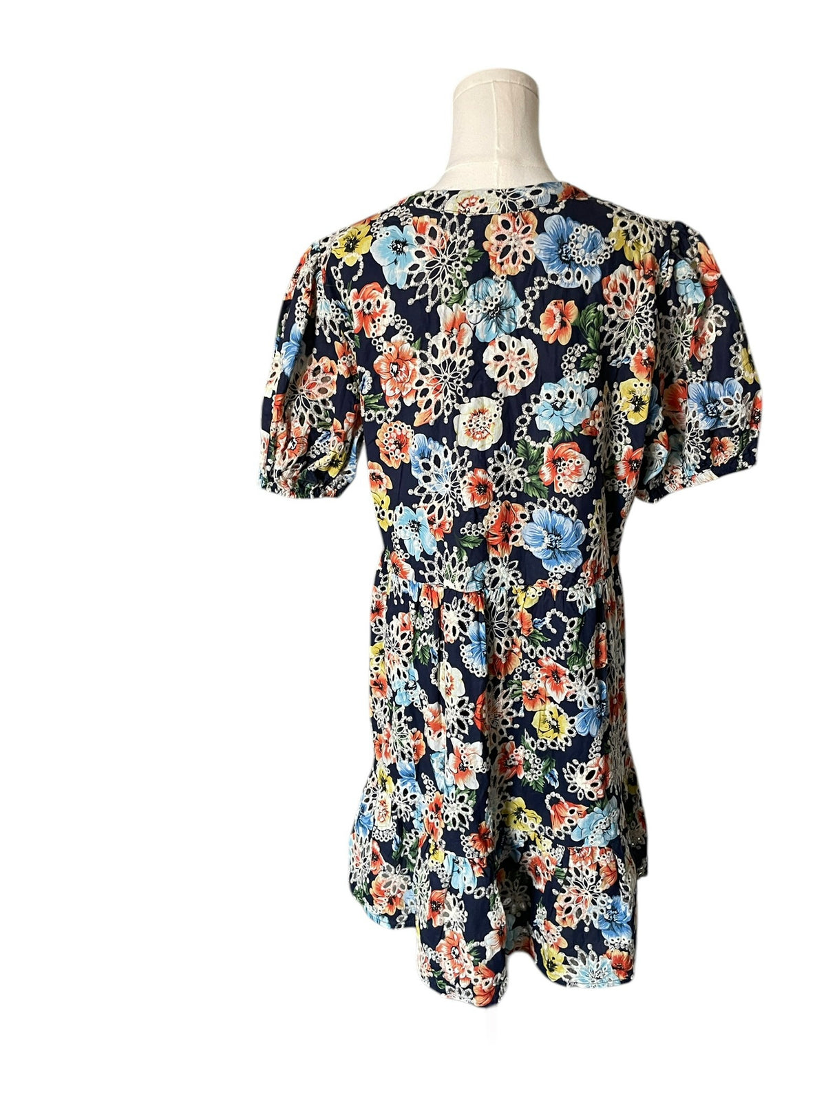 Floral dress on a mannequin against a white background