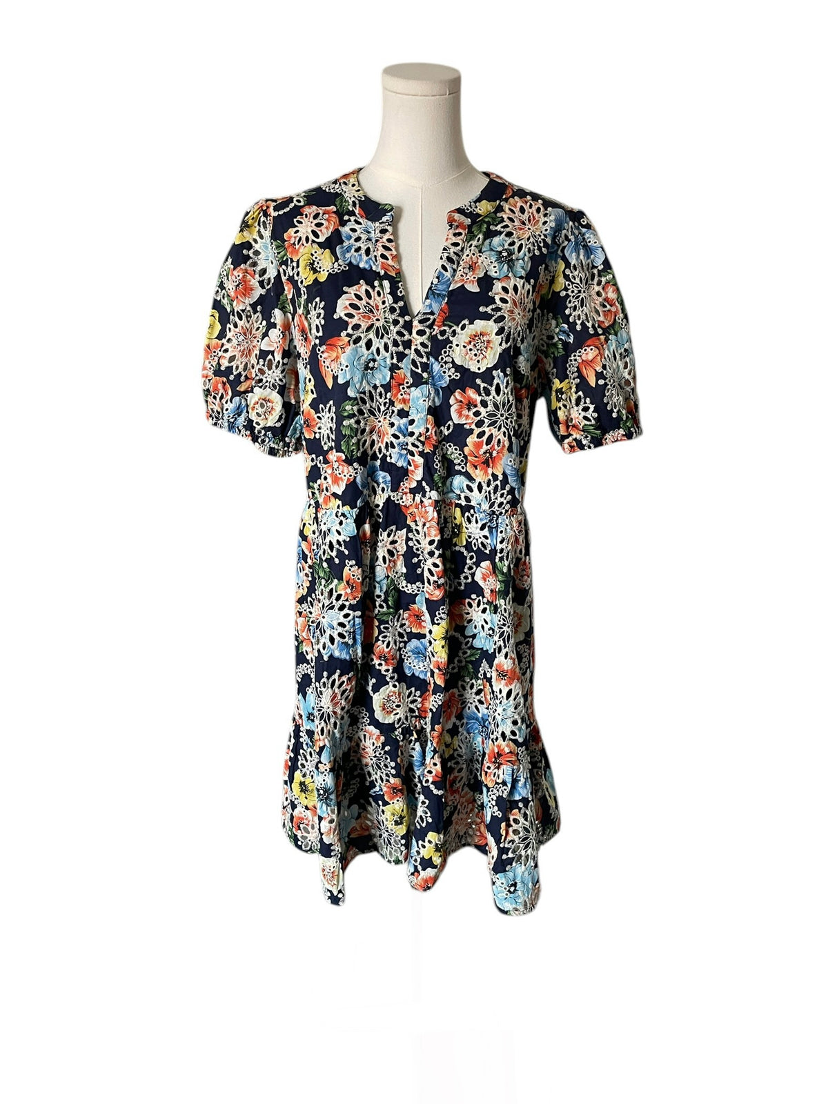 Floral dress on a mannequin against a white background