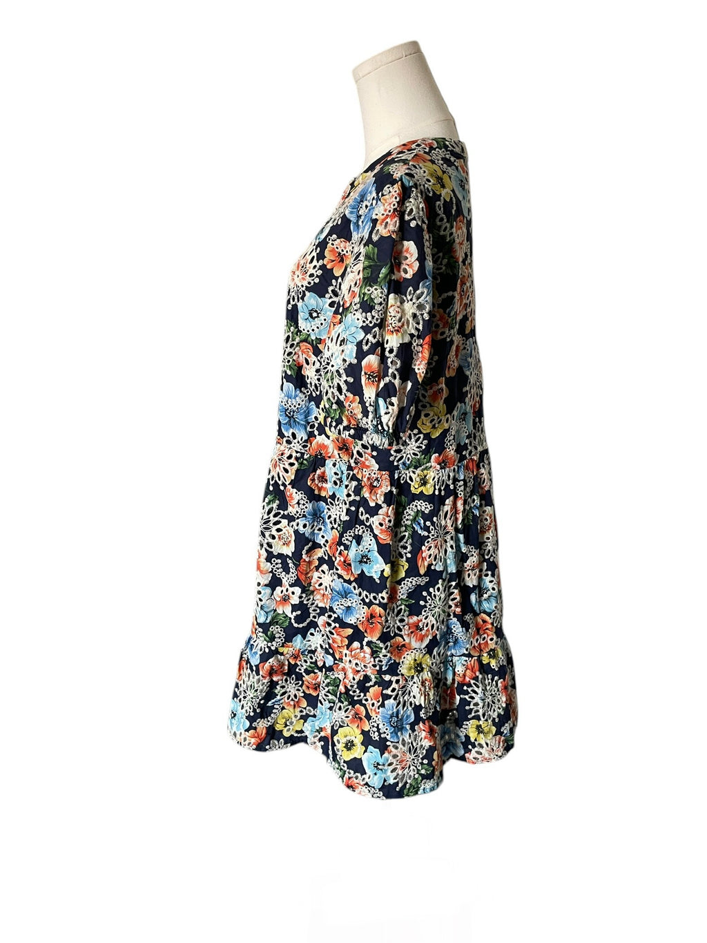 Floral patterned dress on a mannequin against a white background