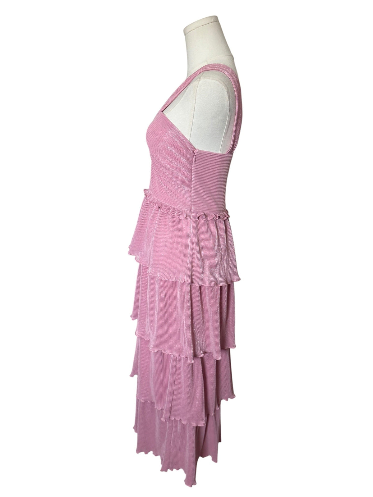 A sleeveless tiered dress in a dusty pink color, displayed on a white mannequin torso against a plain white background.