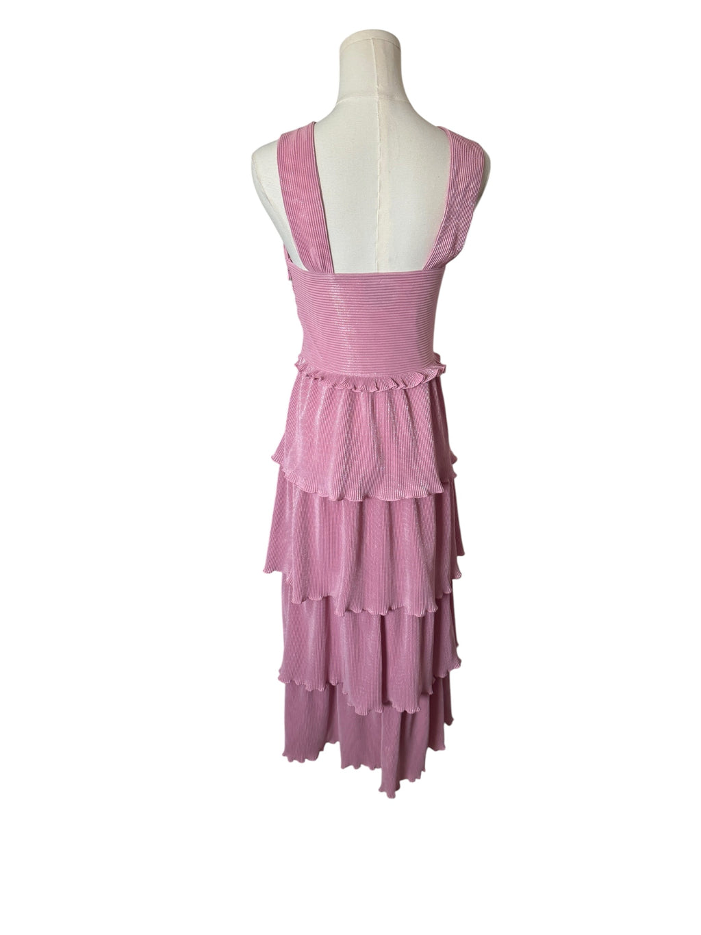 A pink tiered sleeveless dress displayed on a white mannequin torso against a plain white background.