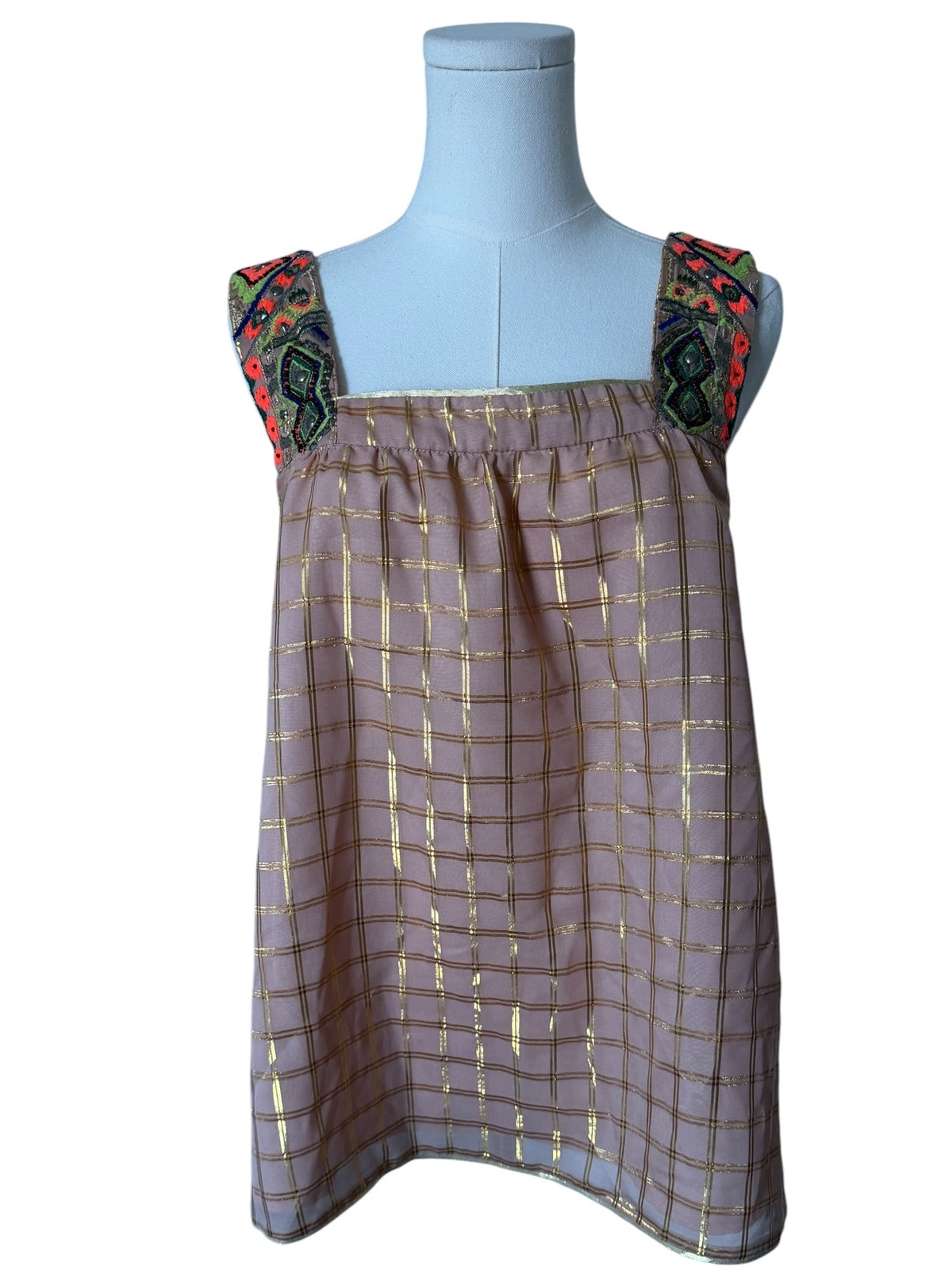 Dress on a mannequin with floral straps against a white background